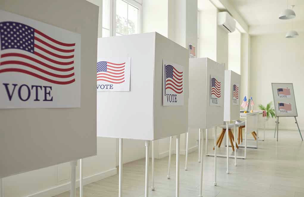 Voting booths with American flag and VOTE Signs