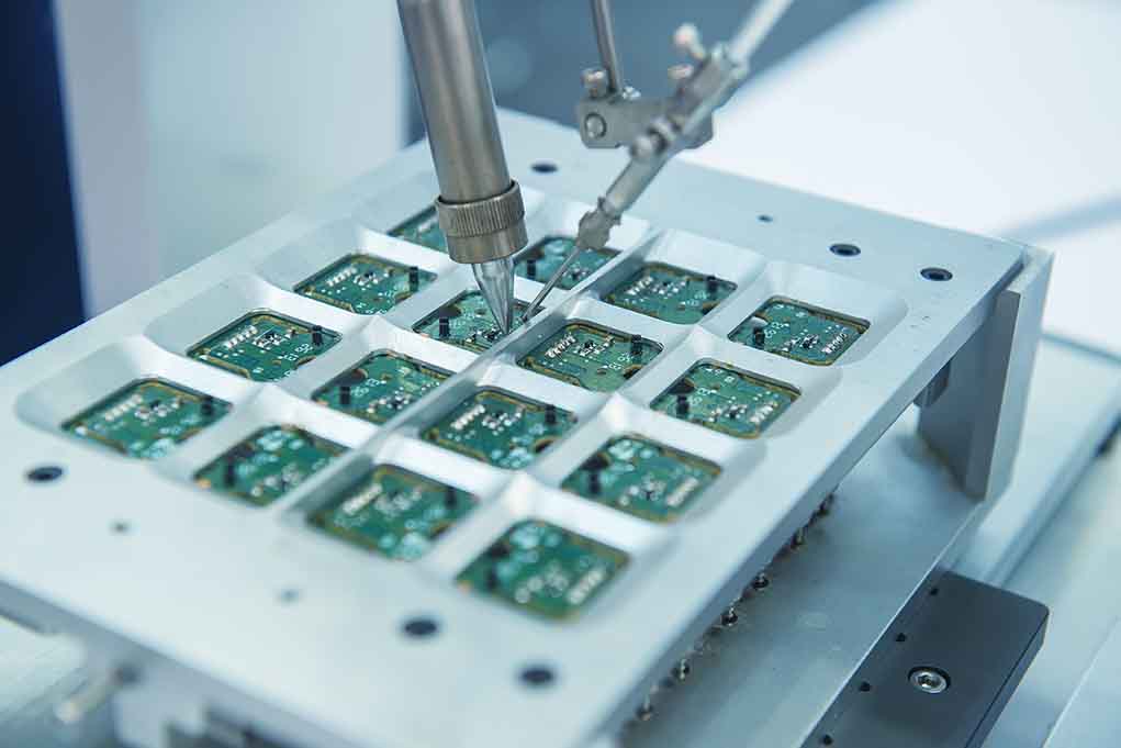 Close up of a soldering machine working on circuit boards
